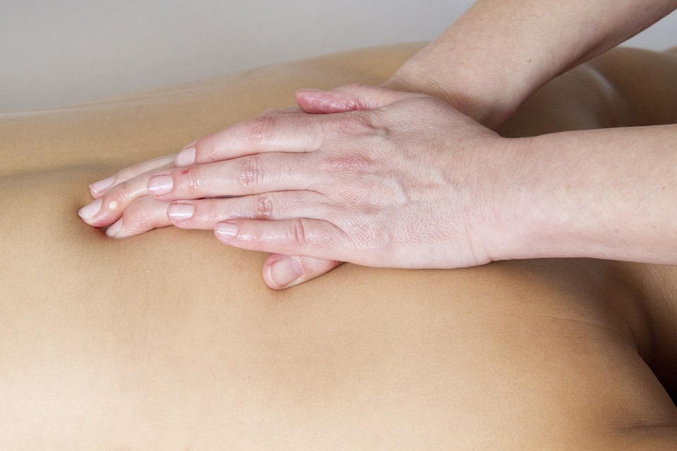 Photo of a lady receiving a back massage