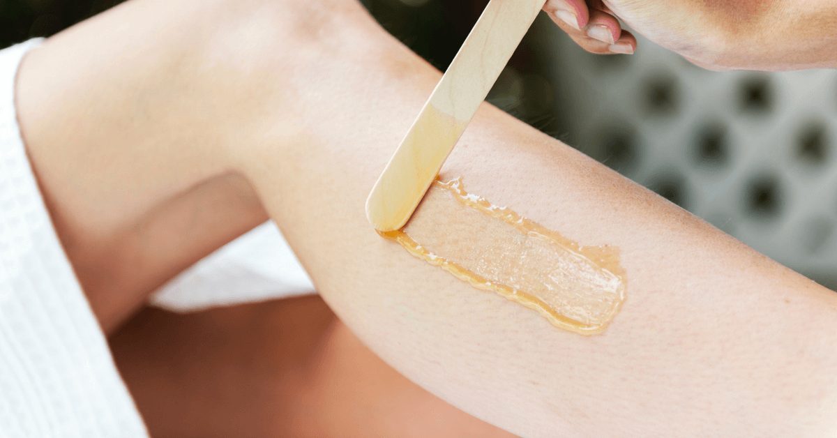 Photo of Wax being applied to a leg